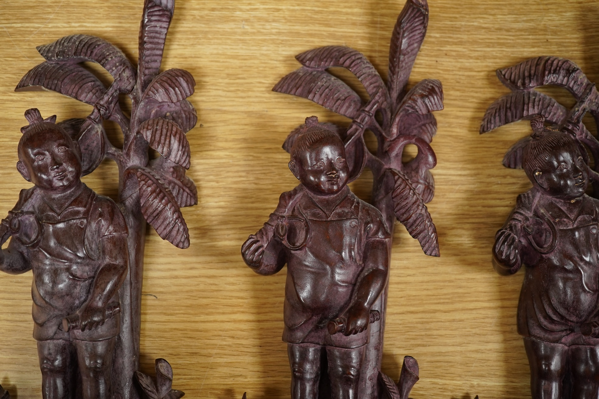 Four 1960's Chinese Cultural Revolution figures of boys holding a rifle, 33cm high